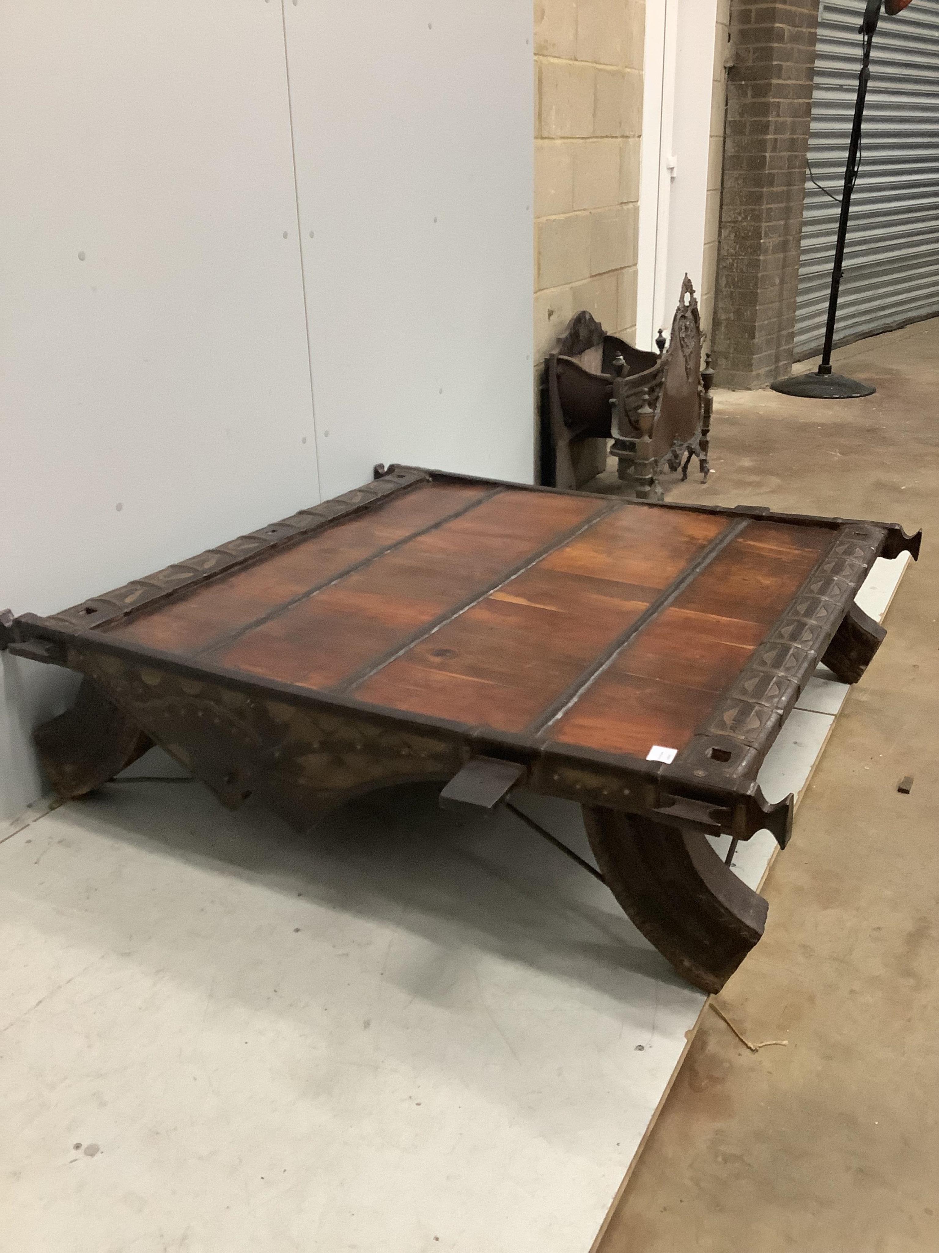 An Indian hardwood and iron mounted low square table, width 138cm, depth 130cm, height 33cm. Condition - fair